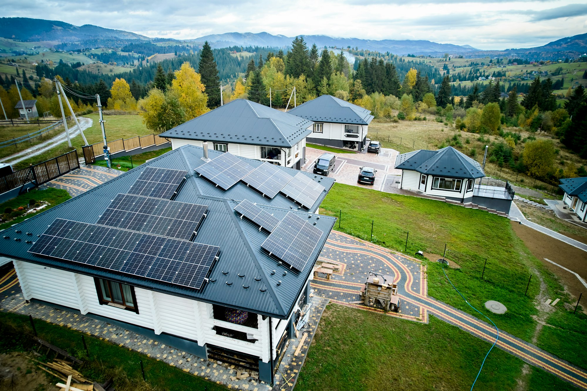 Modern house cottage in the mountains with solar photovoltaic panel system on roof.